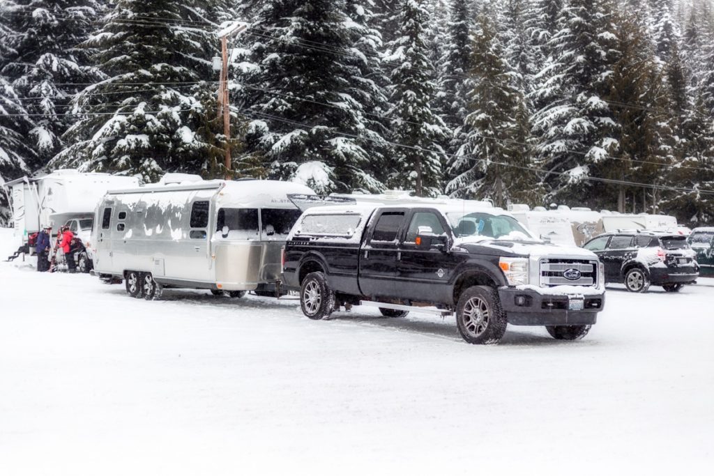 Ford Truck and Airstream Travel Trailer covered in snow
