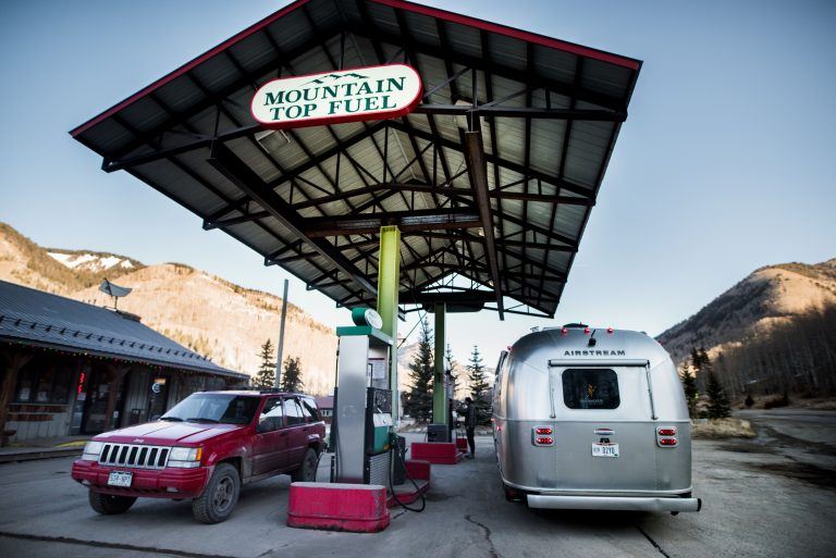 Airstream at Gas Station Refueling the Tow Vehicle Travel Trailer RV