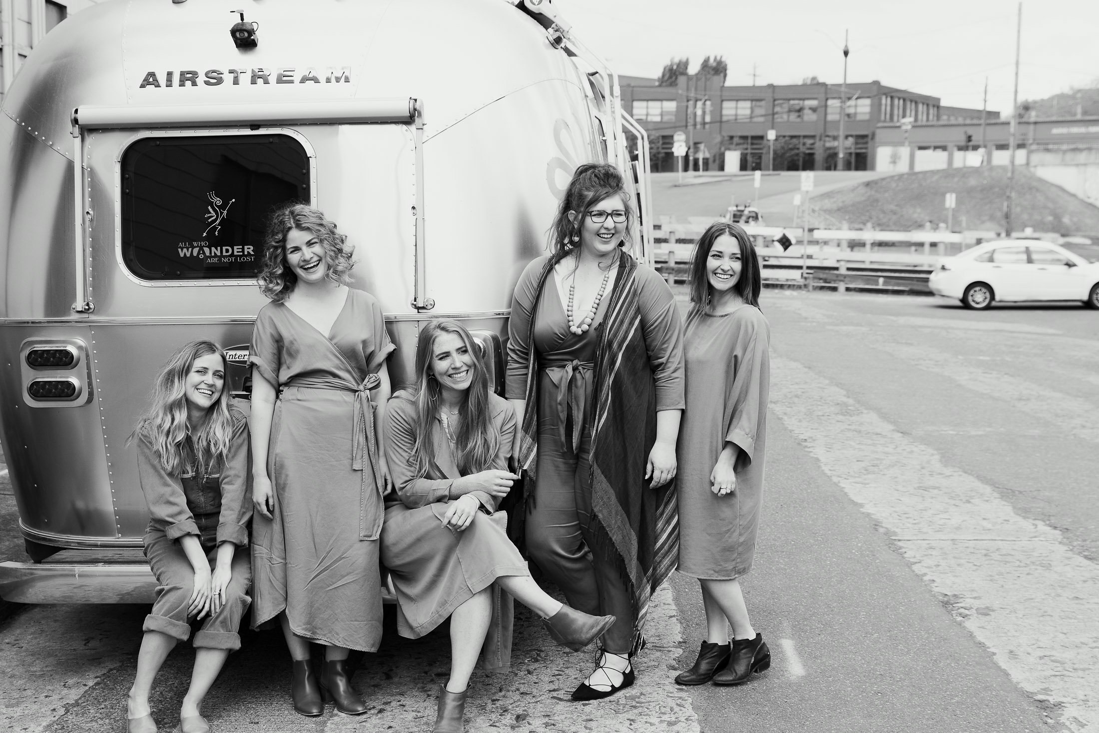 The Yellow Co. girls stand in front of their Airstream