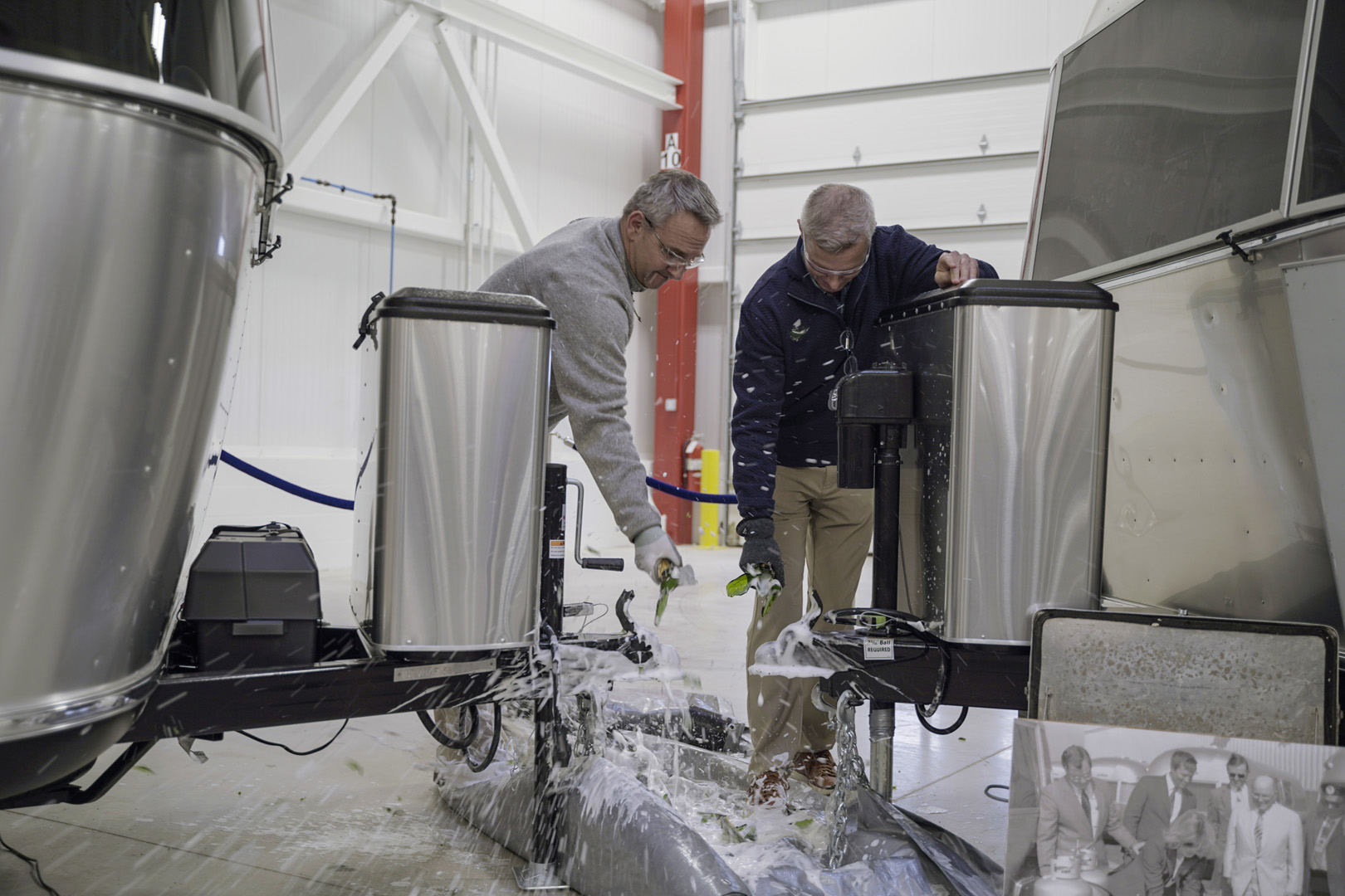 Airstream Christening Ceremony Justin and Bob Breaking Bottles