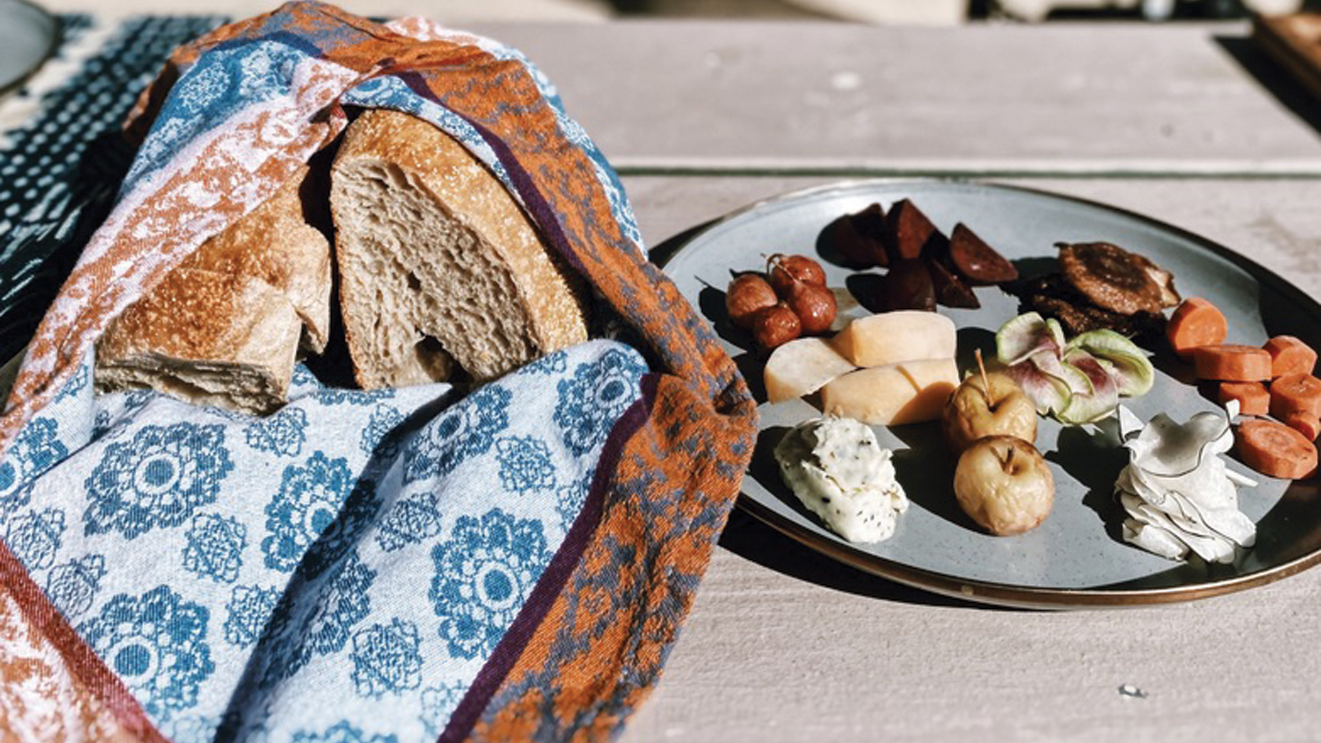 A plate of food and bread sitting on a table