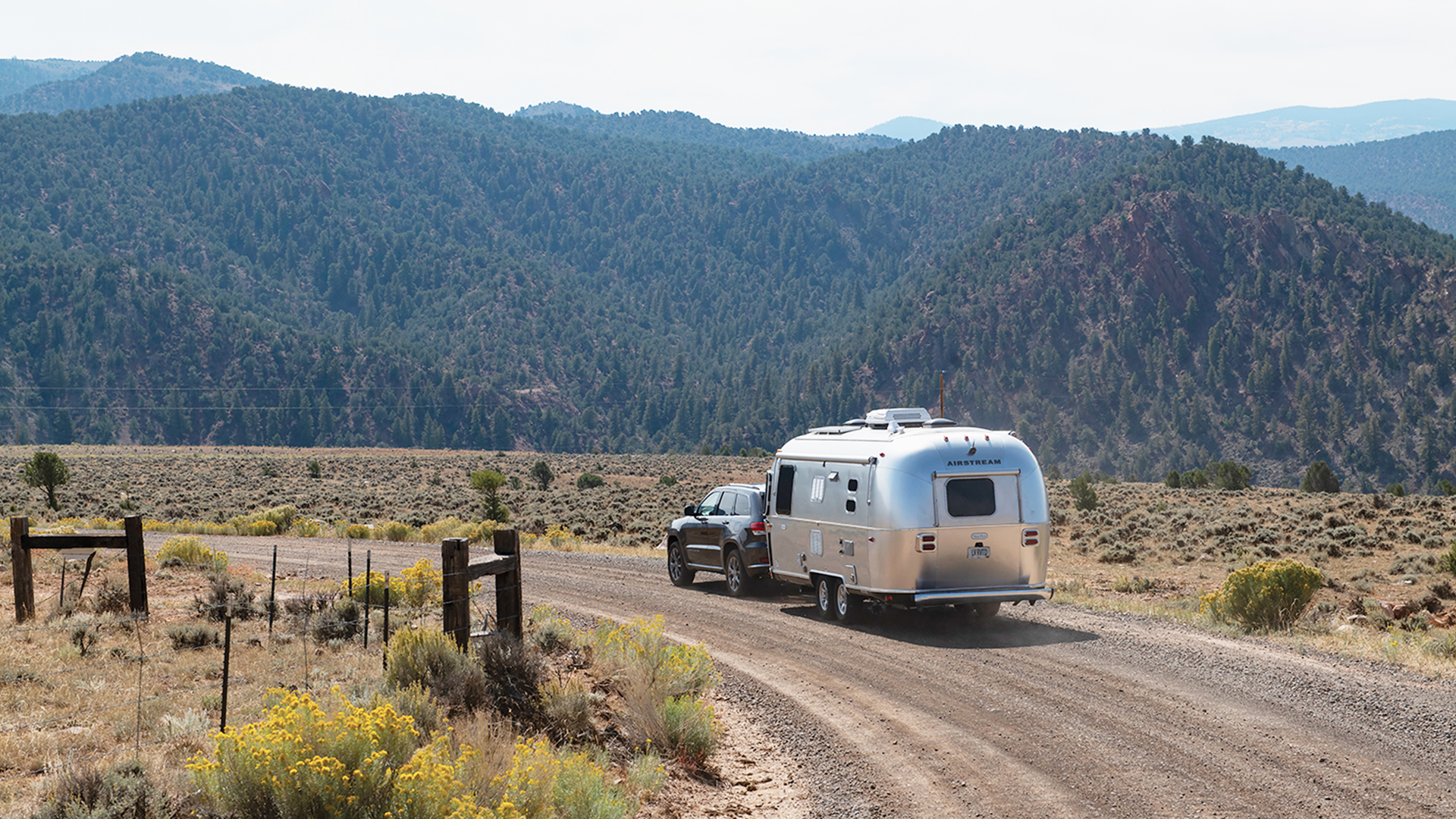 Airstream-Travel-Trailer-with-Mountains-Driving