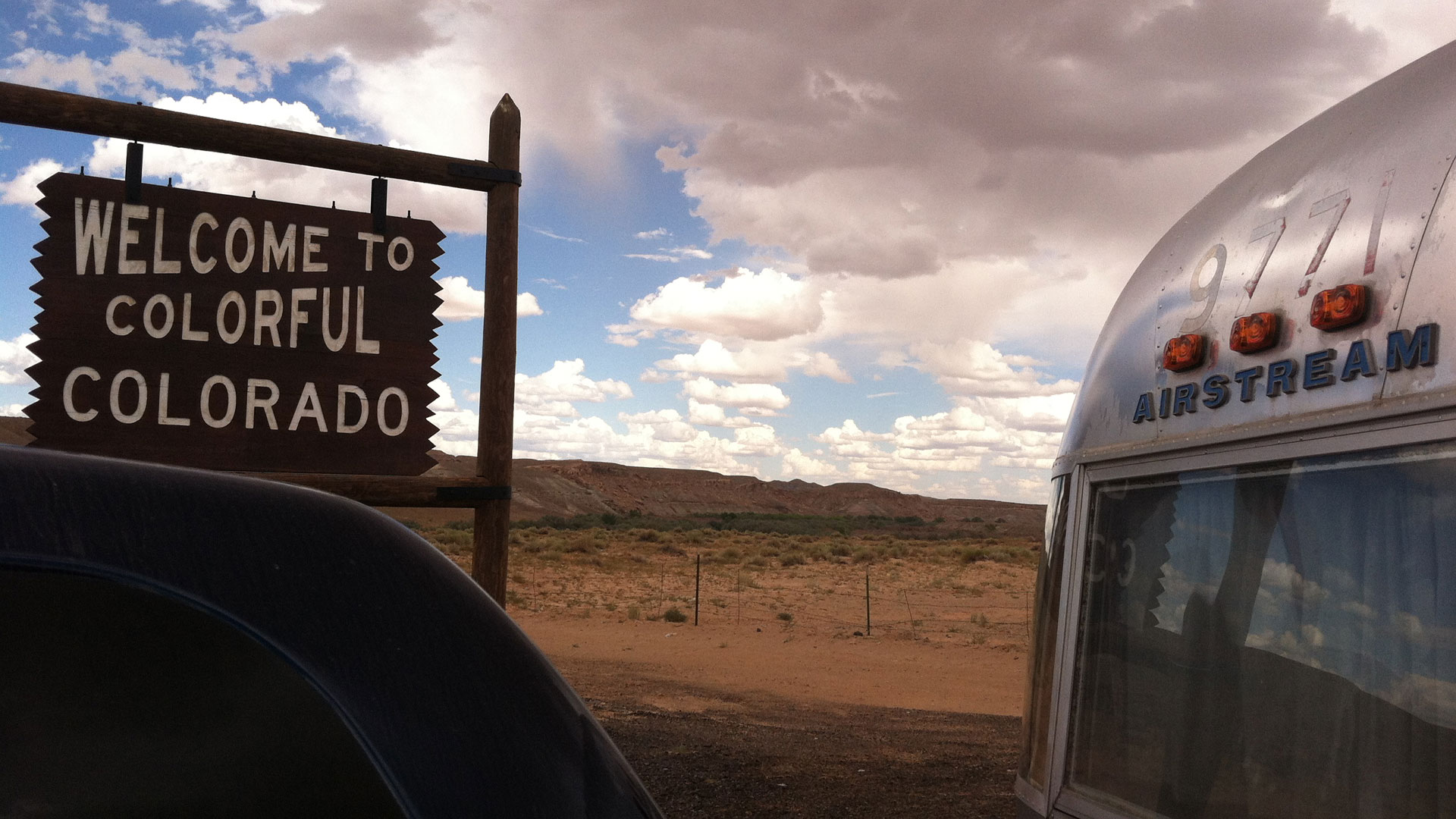 Airstream Classic Trailer sitting in front of a Welcome to Colorado sign