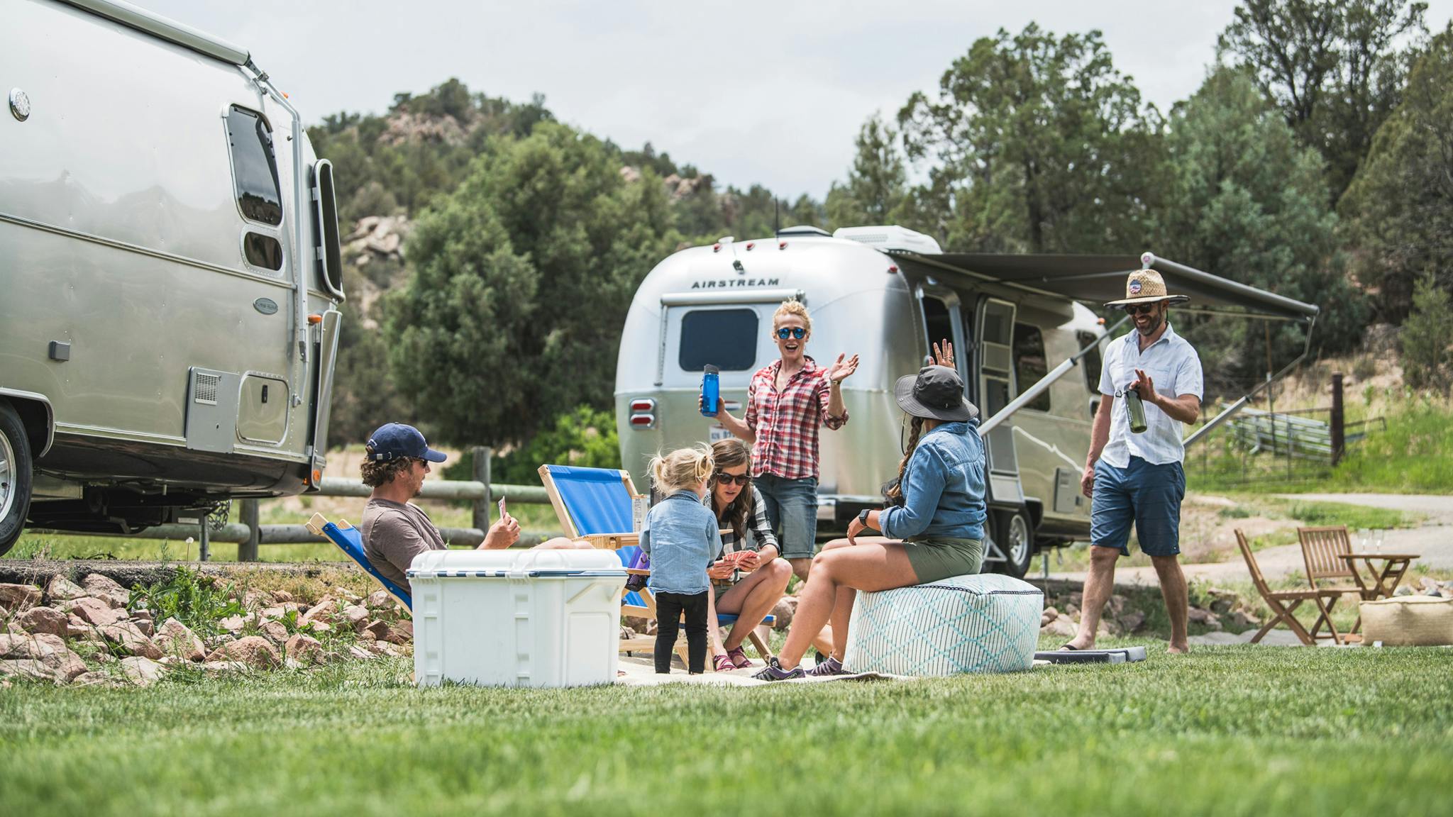 People hanging out outside their Airstream Trailers