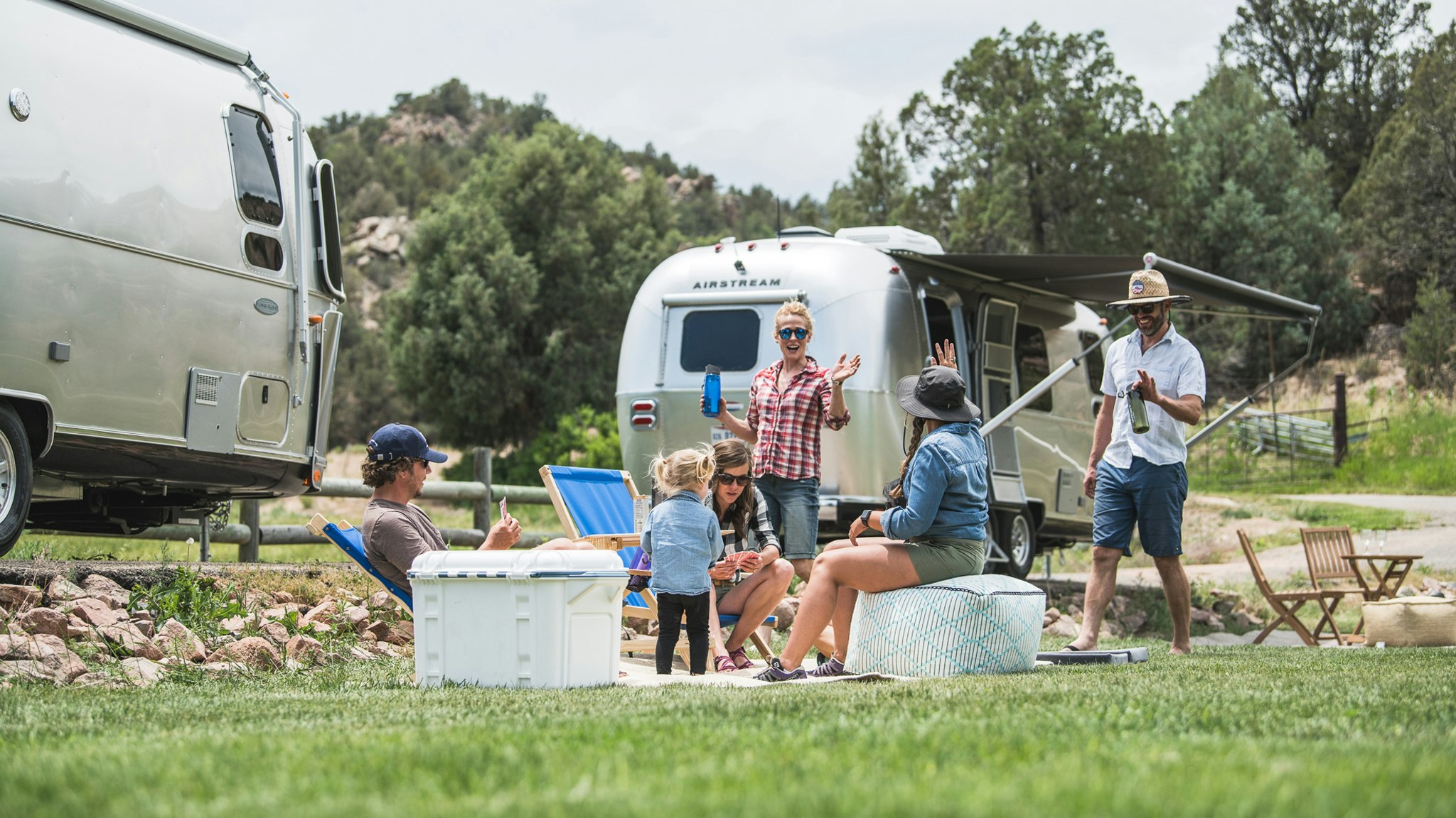 People hanging out outside their Airstream Trailers