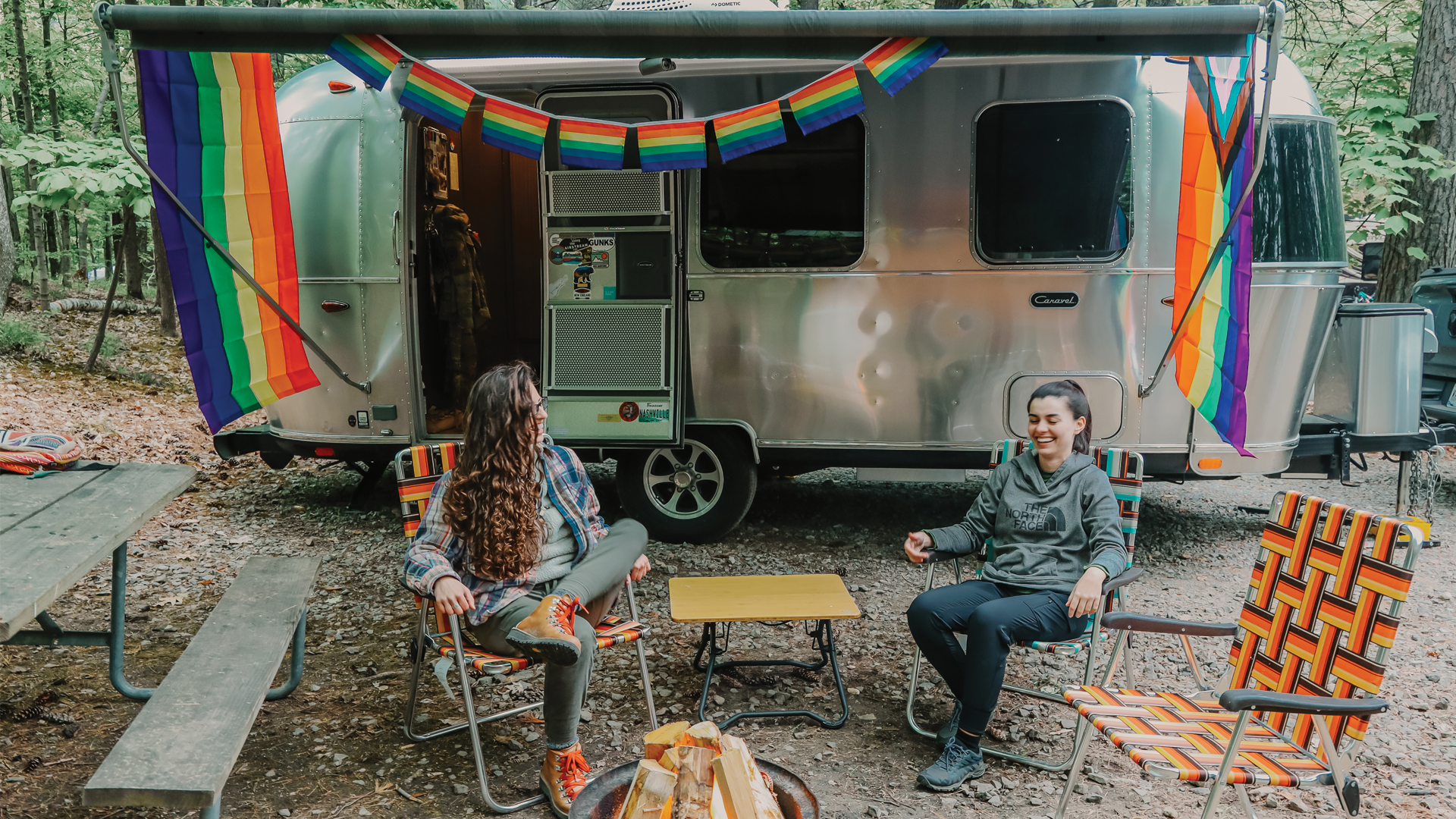 Airstream Ambassador Marisa and her girlfriend sitting outside of her Airstream Travel Trailer