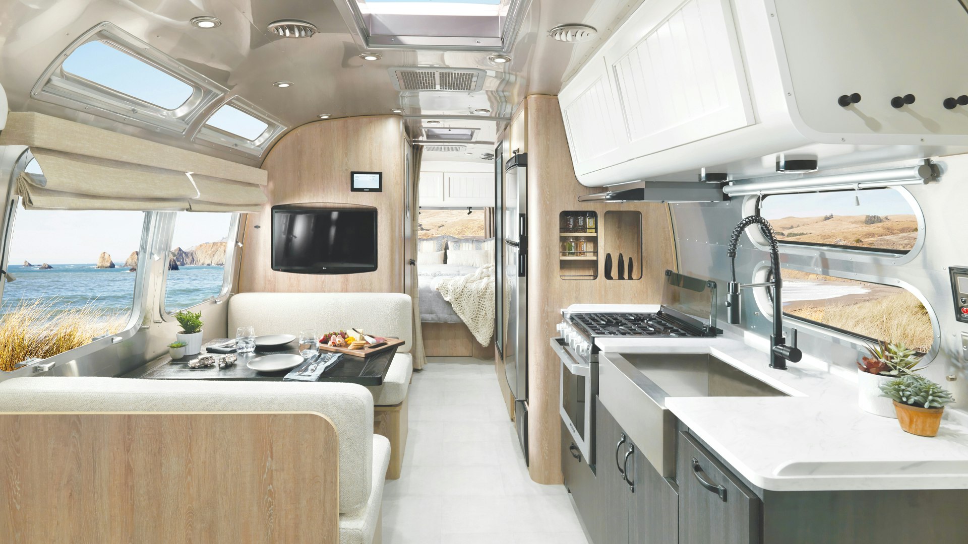Airstream Pottery Barn Special Edition Travel Trailer interior image of dining space, kitchen, and bedroom