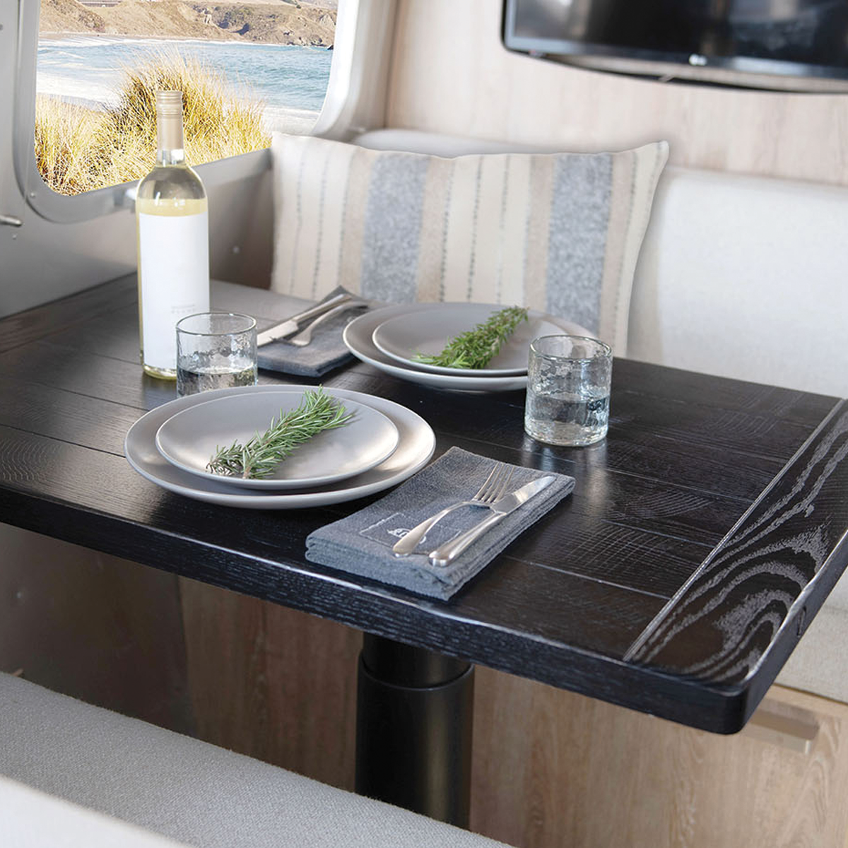 Airstream Pottery Barn Special Edition Travel Trailer wood table in the dining space