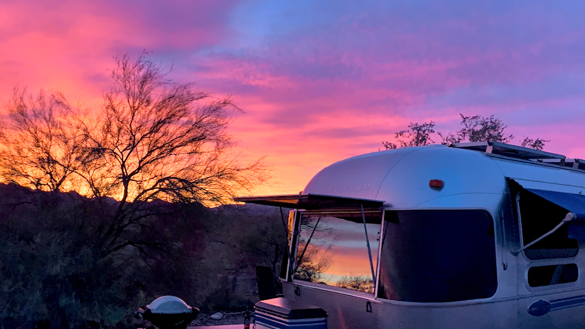 Airstream with a pink sunset