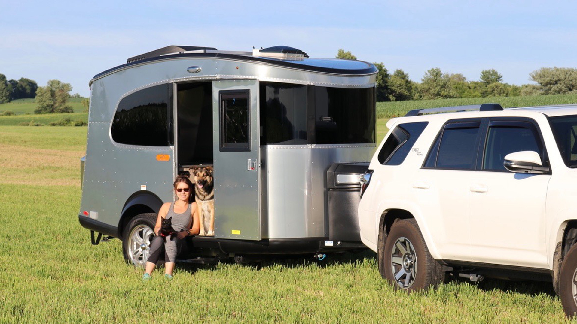 Airstream Ambassador, Cass, sitting in her Basecamp with her pets
