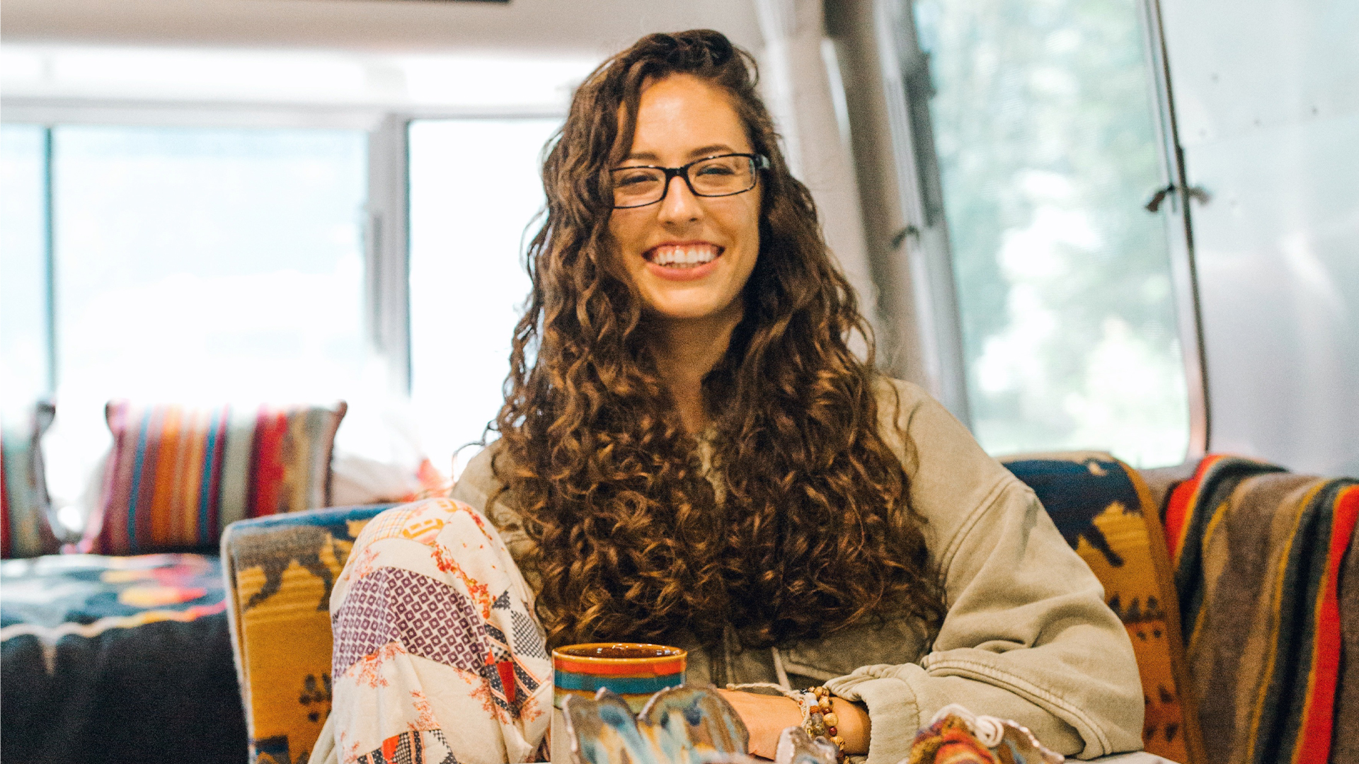 Airstream Ambassador, Marisa, sitting in her Airstream