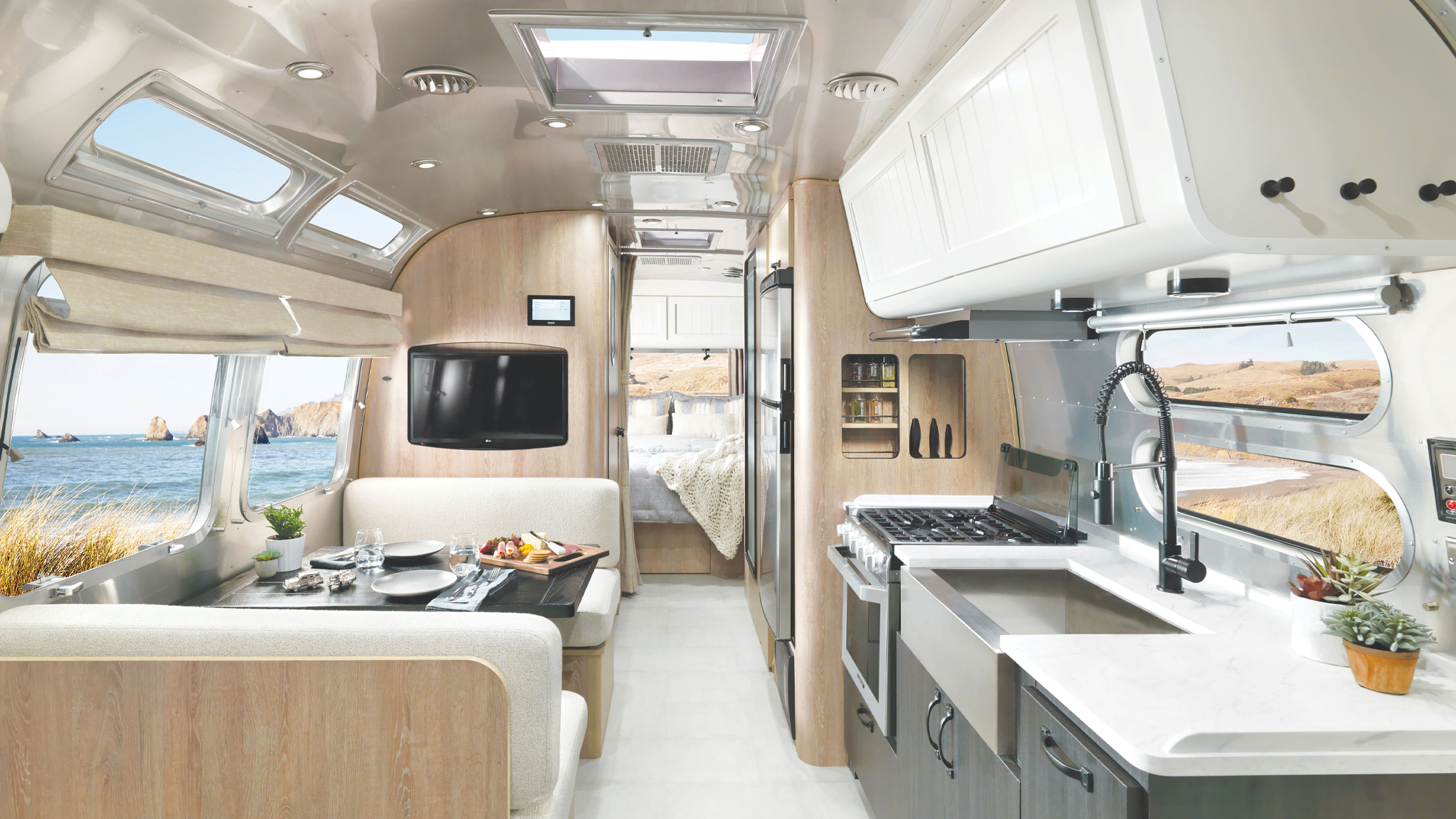 Airstream Pottery Barn Special Edition Travel Trailer interior image of kitchen, dining space, and bedroom