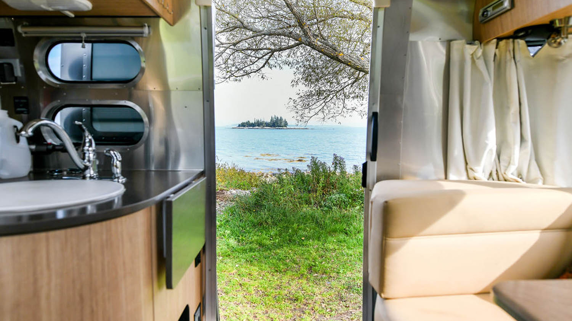 Looking out of an Airstream at a lake in Maine