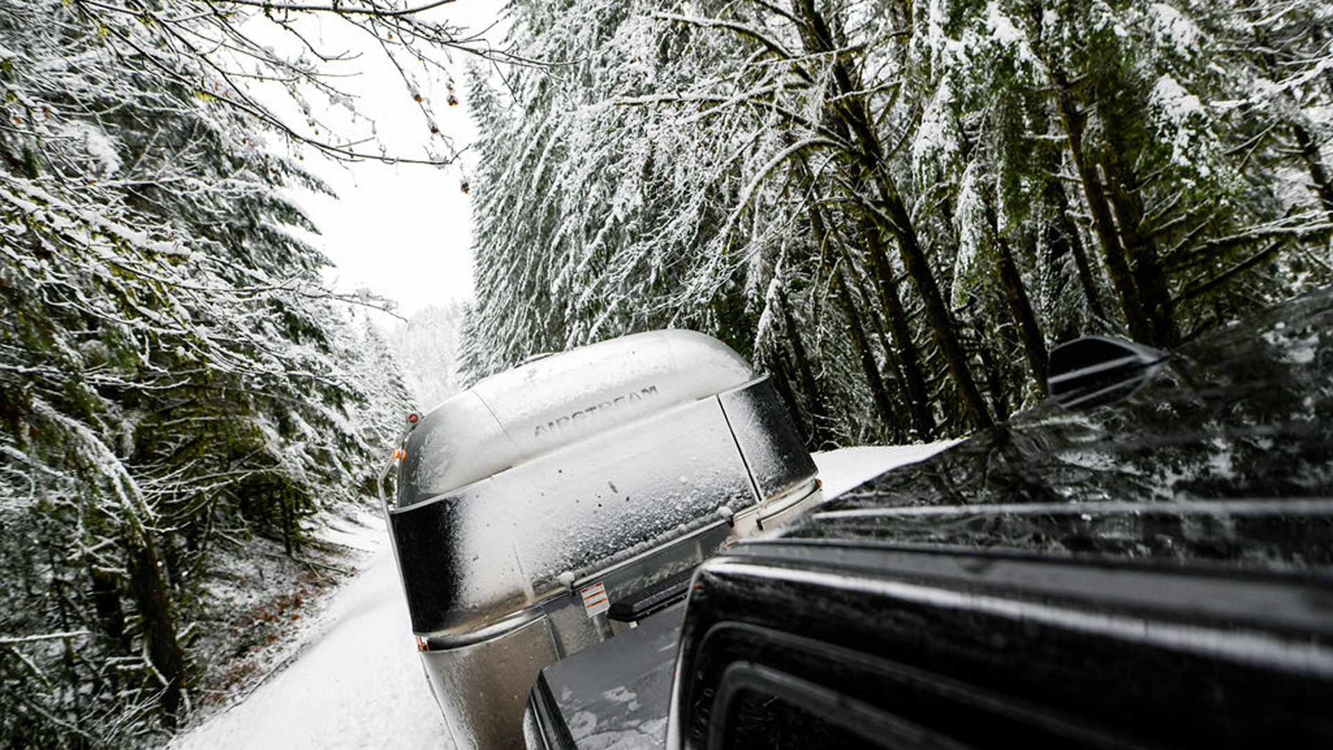 Airstream being towed through snow