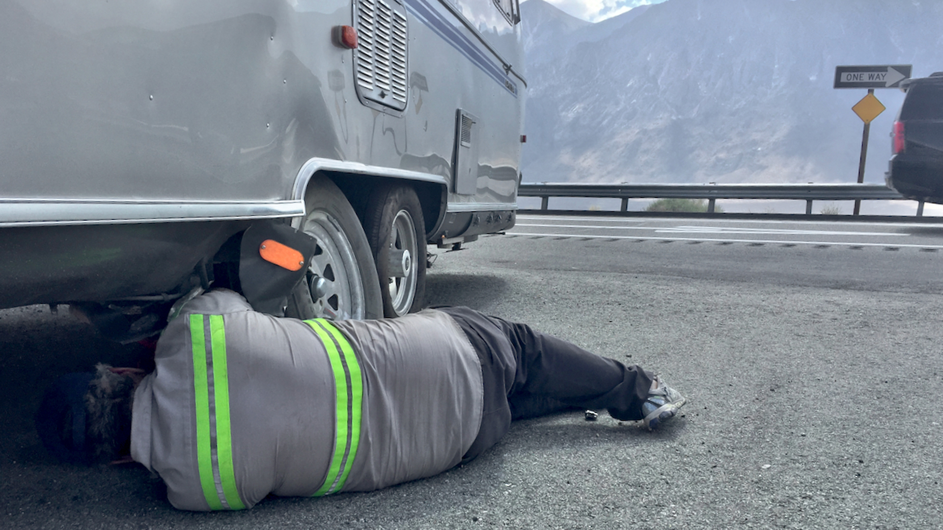 Jim fixing the tire on his Airstream Travel Trailer on the side of the road