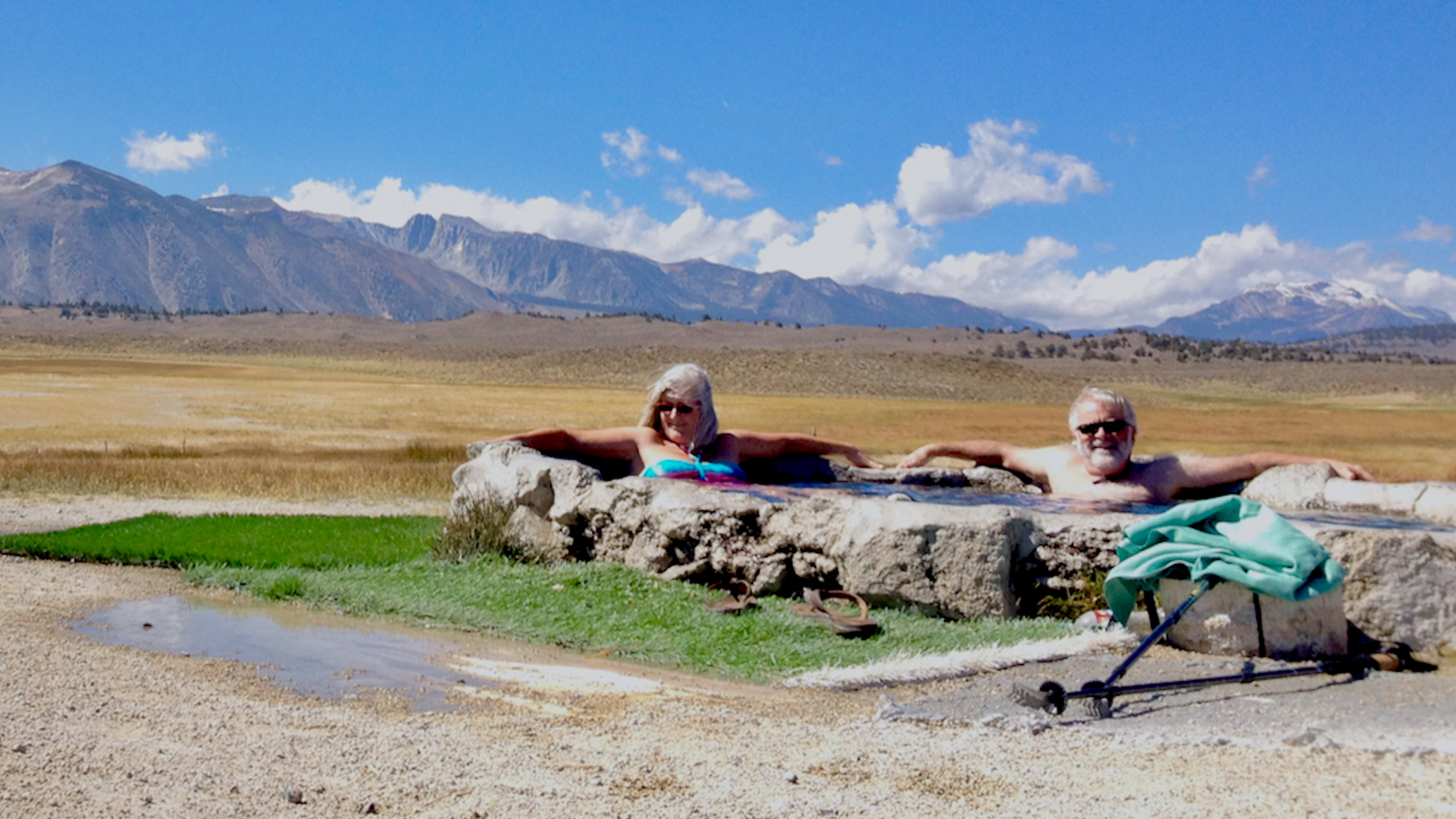 Jim and Carmen sitting in a hot spring