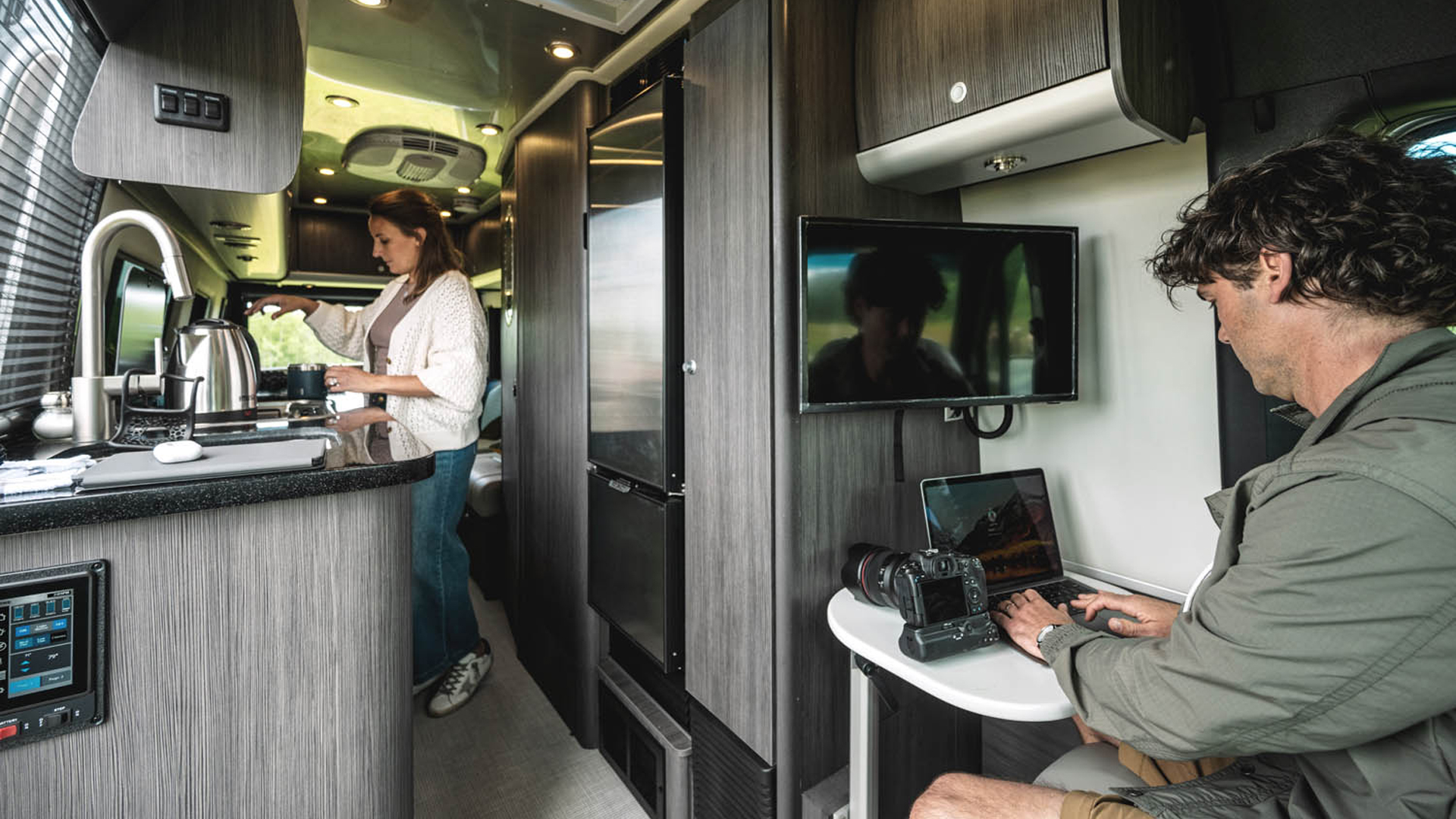 Checking emails and getting a snack in an Airstream Class B Motorhome