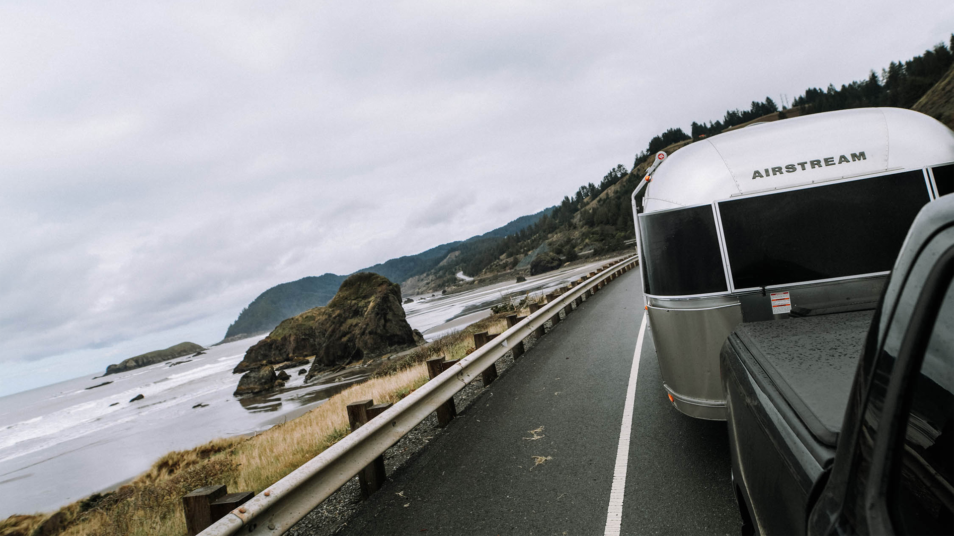 A truck towing an Airstream Travel Trailer on the coast