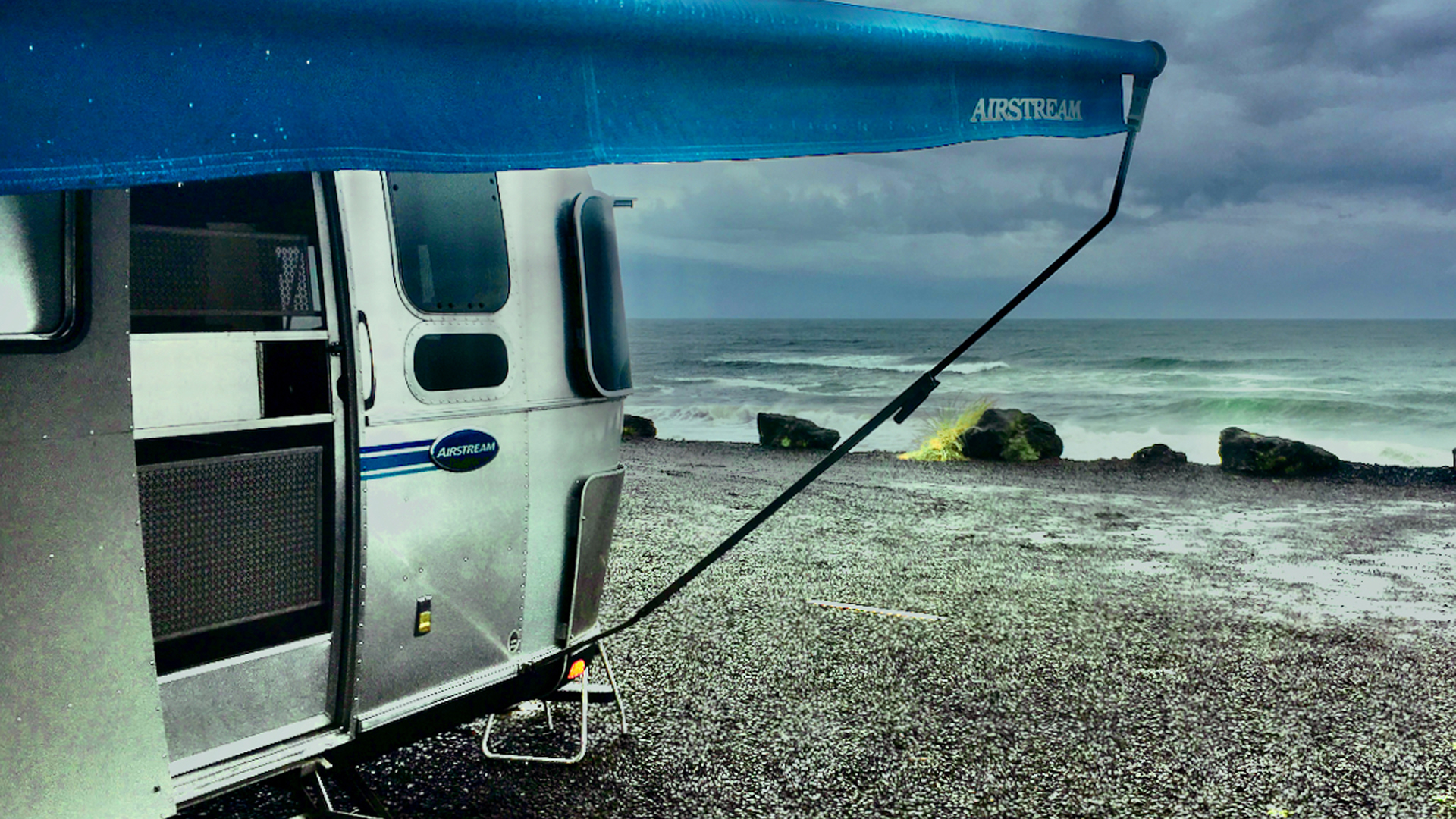 Airstream Travel Trailer parked in the sand at a beach