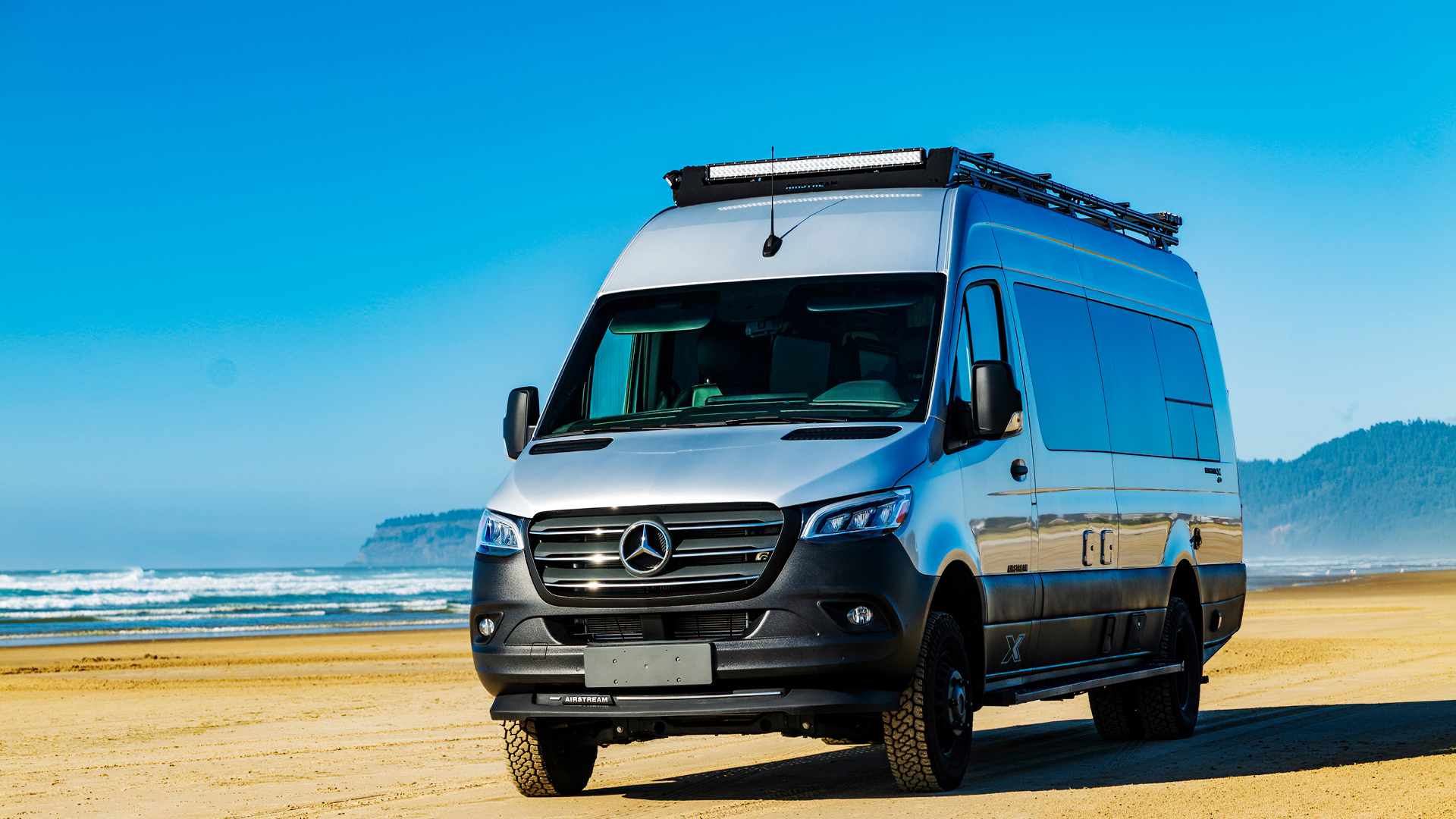 Airstream Interstate 24X parked on a beach in the Pacific Northeast.