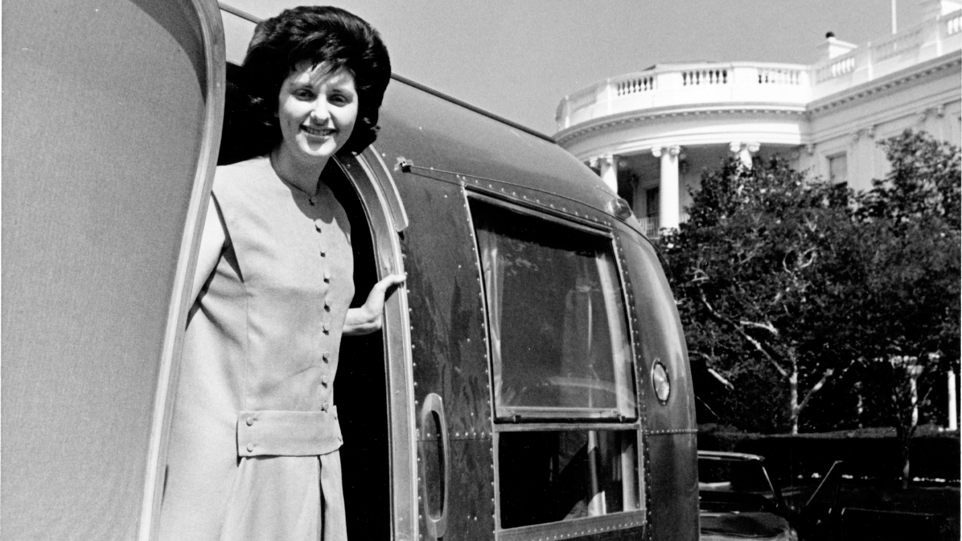 Lynda Johnson hanging out of an Airstream door in front of the White House in Washington D.C.