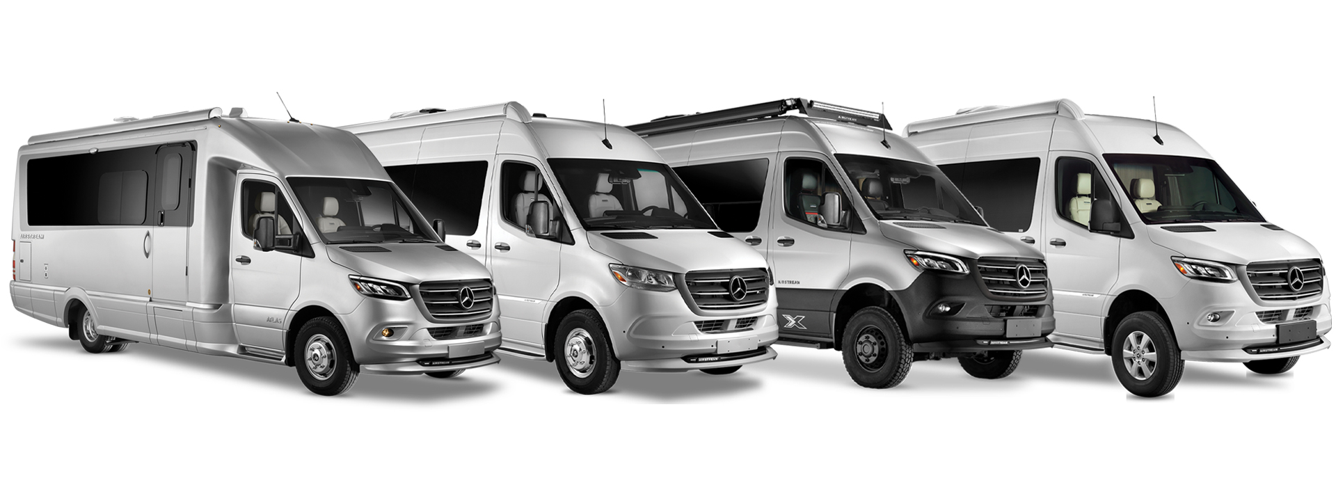 All Airstream Touring Coaches lined up next to each other on a white background.