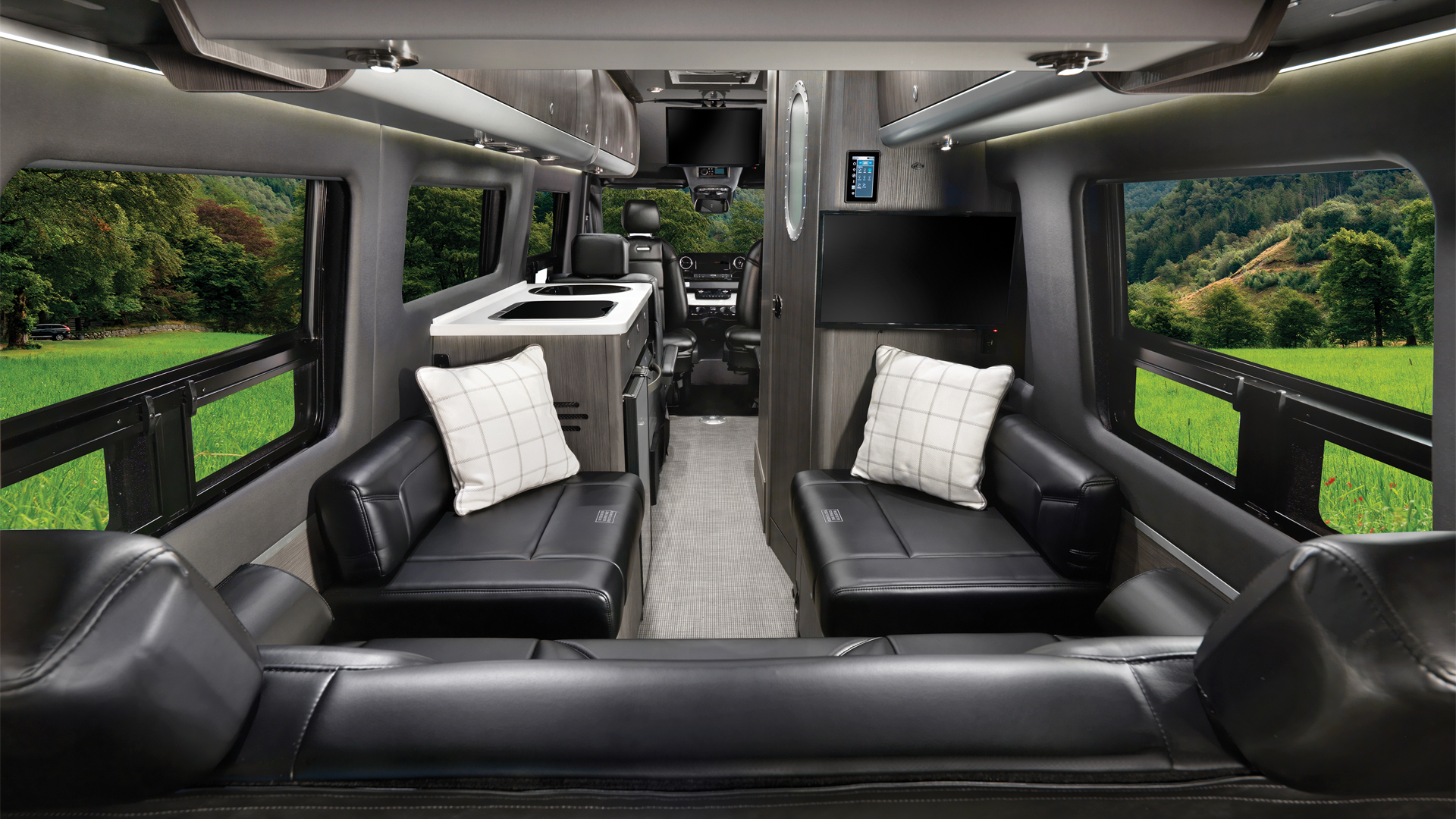Airstream Interstate 24GL Touring Coach with the formal black interior and looking from the back to the front of the Class B motorhome