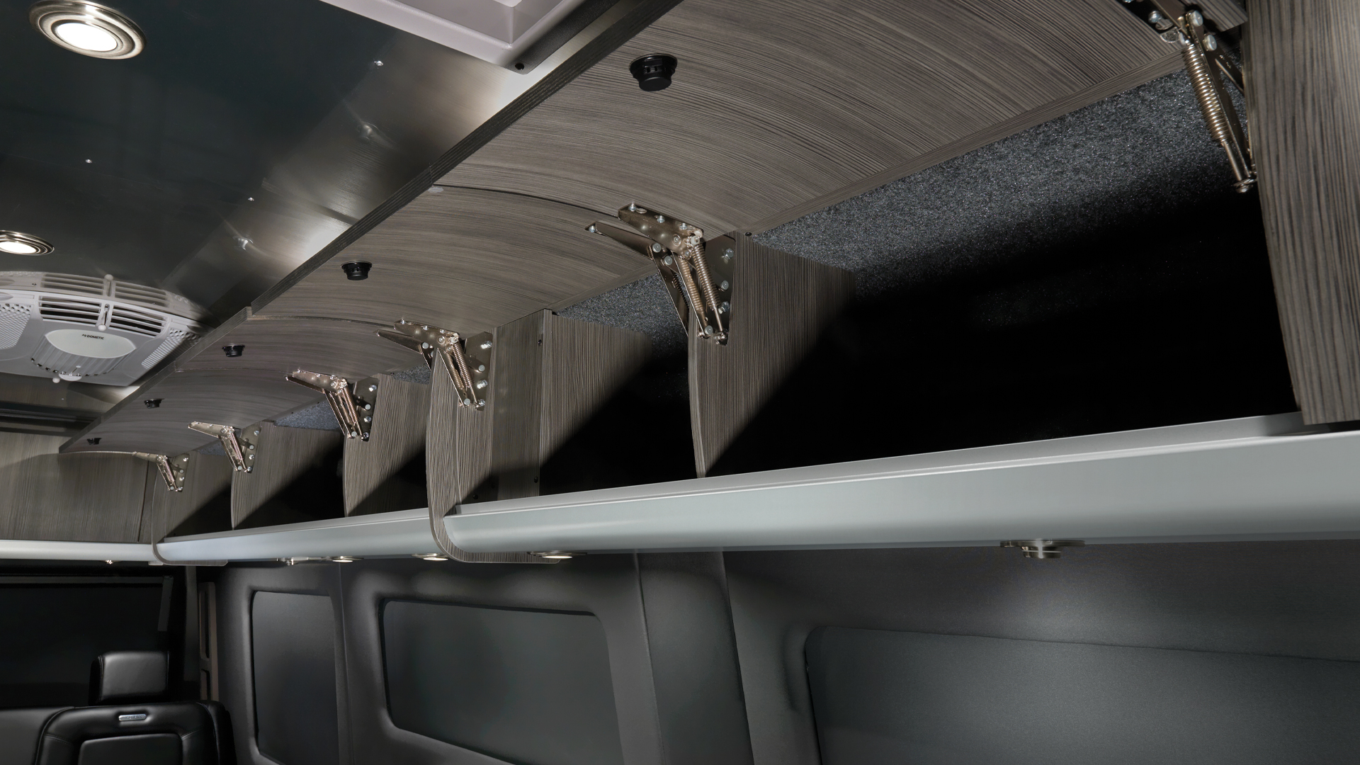 Airstream Interstate 24 Touring Coach with the Formal Black interior and overhead cabinets open