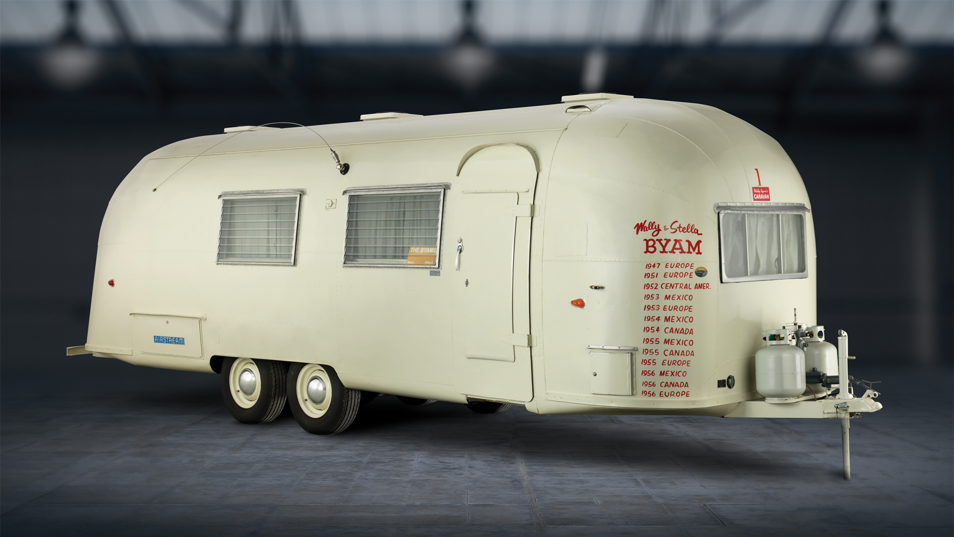 Wally Byam's vintage White Trailer with red paint of places visited on the front