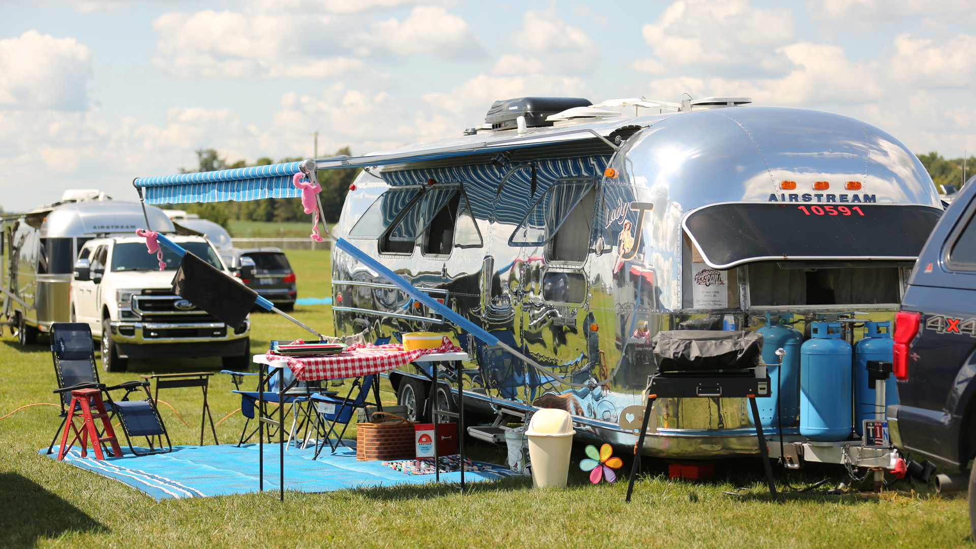 A vintage Airstream has its campsite all set up for Alumapalooza in Jackson Center, Ohio