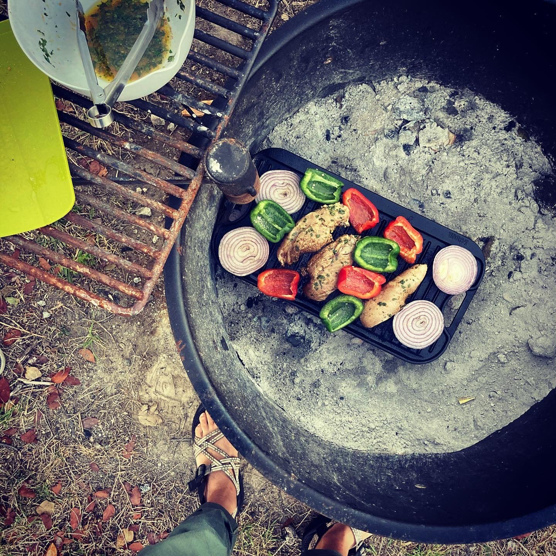 Fajitas being cooked over a fire.