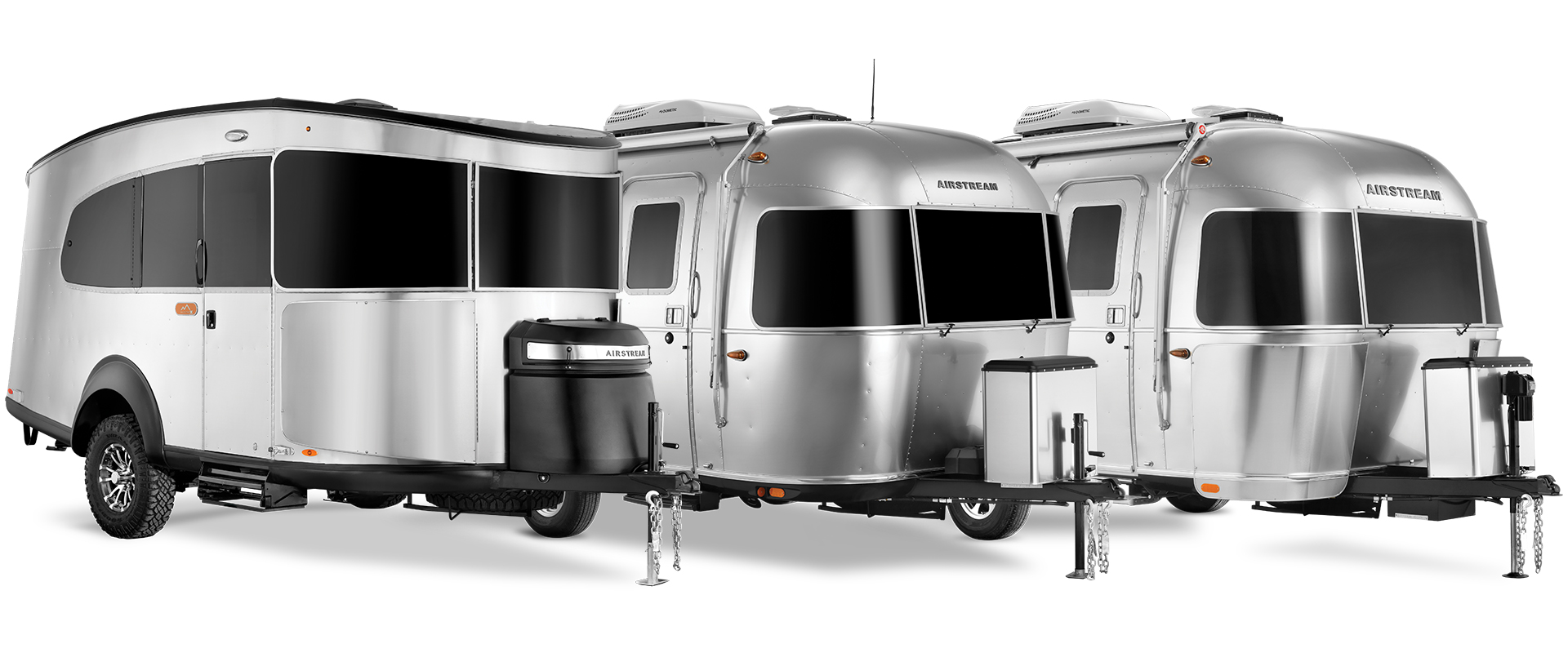 Airstream travel trailers Basecamp, Bambi, and Caravel lined up on a white background.
