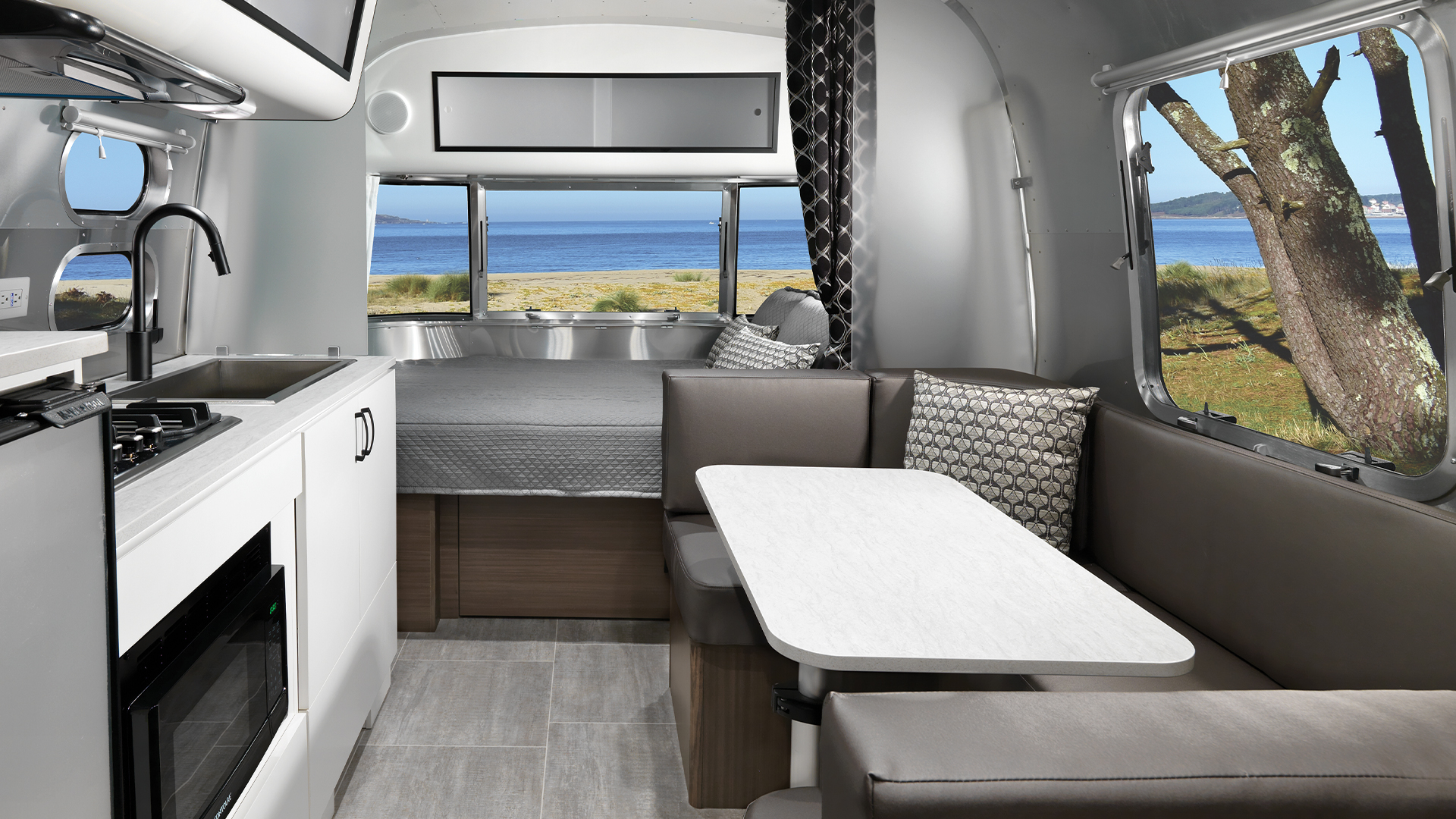 A panoramic view out of the windows of an Airstream Caravel travel trailer.