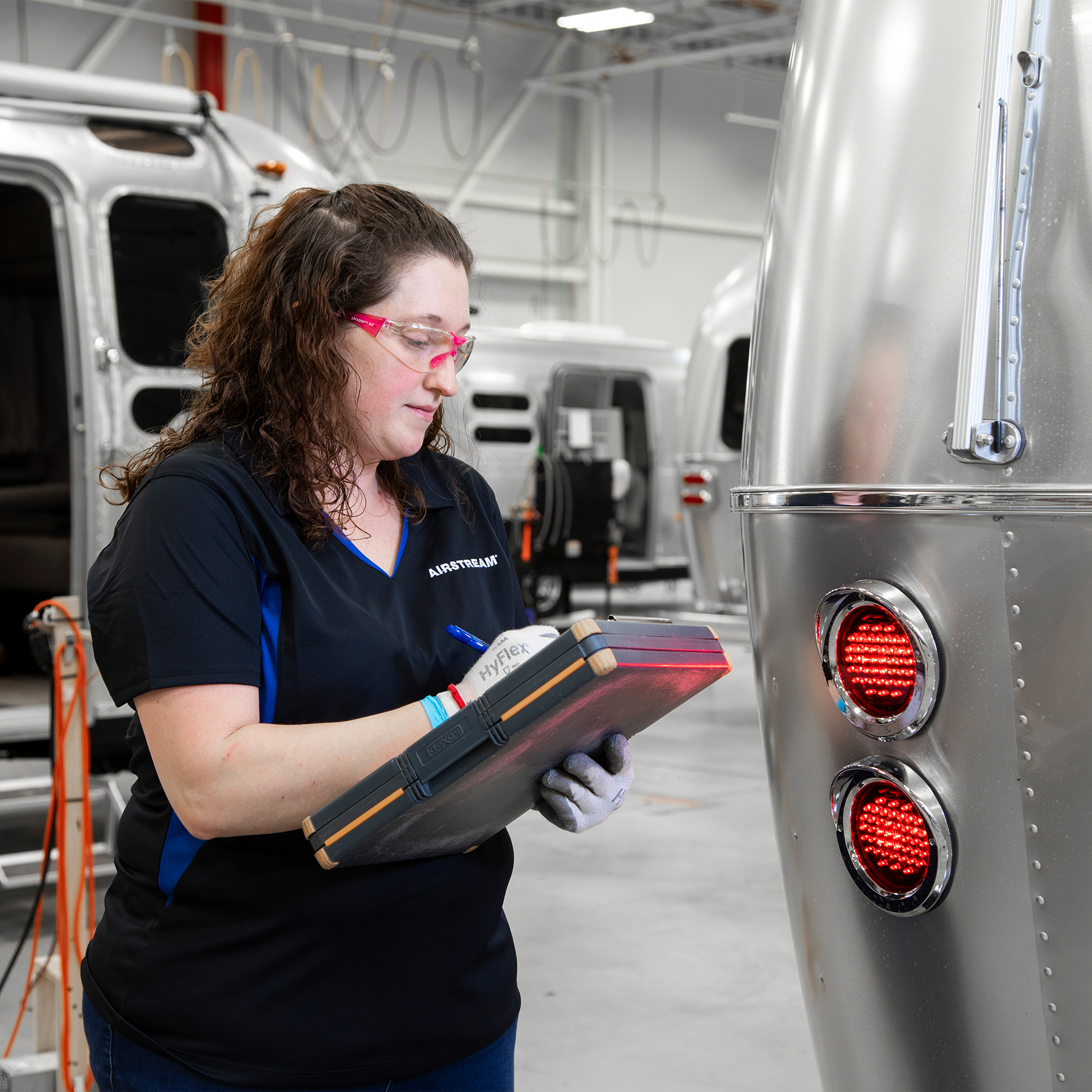 An Airstream employee checking the quality of an Airstream travel trailer.