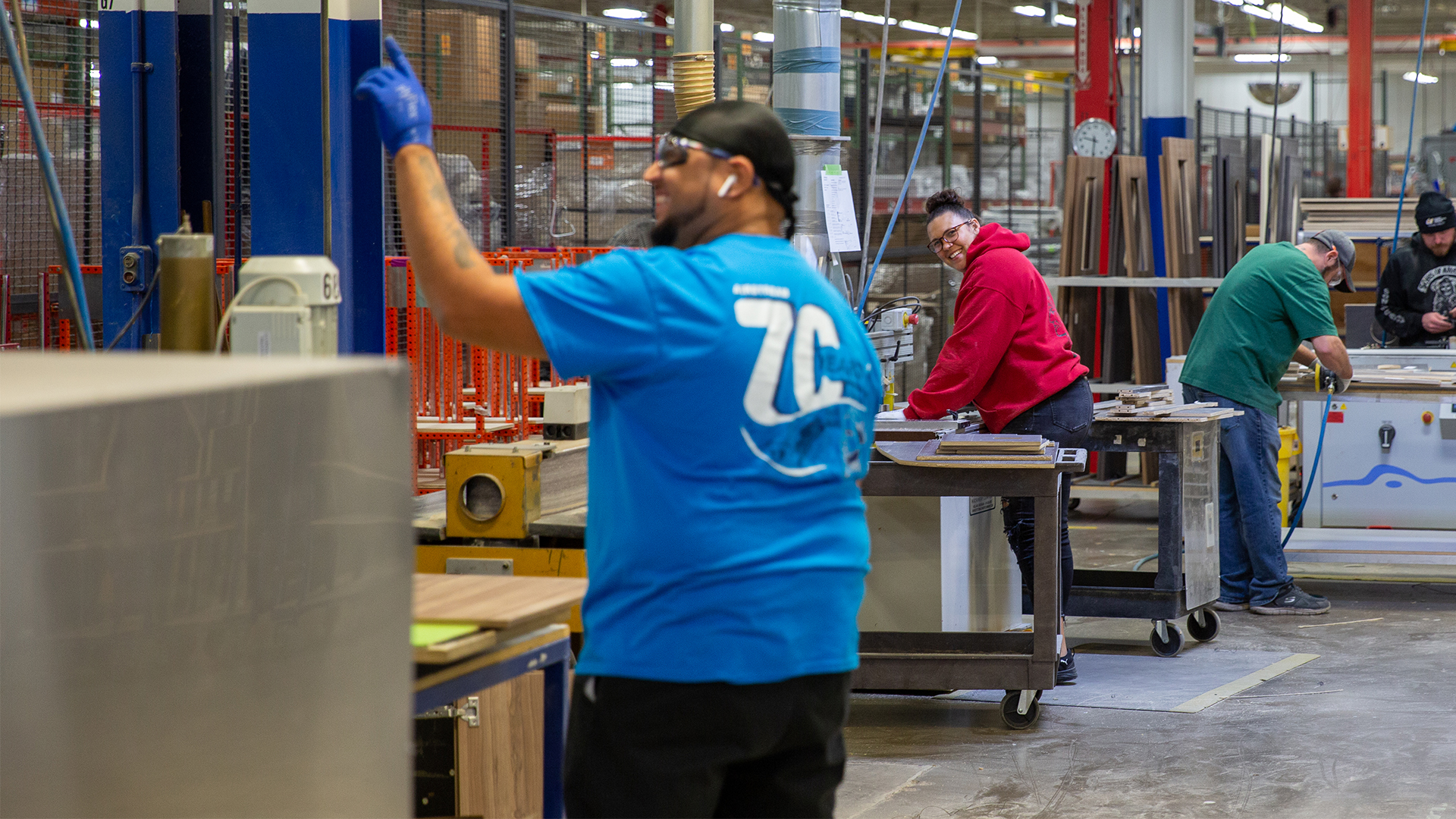 A man and woman Airstream employee laughing while they work in the Airstream Class B Motorhome plant.