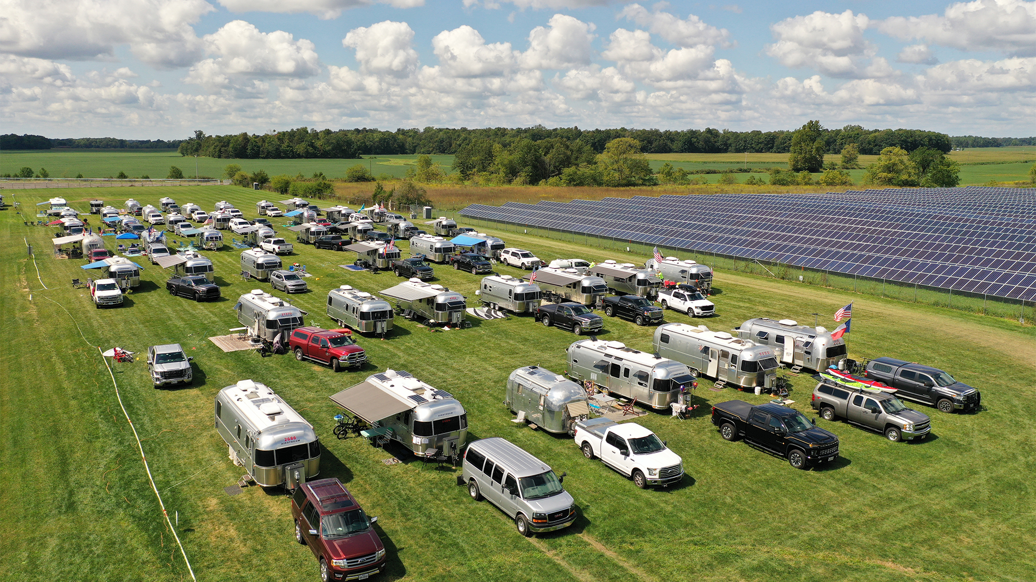 A bunch of Airstreams are camping in a field in Jackson Center for a rally.