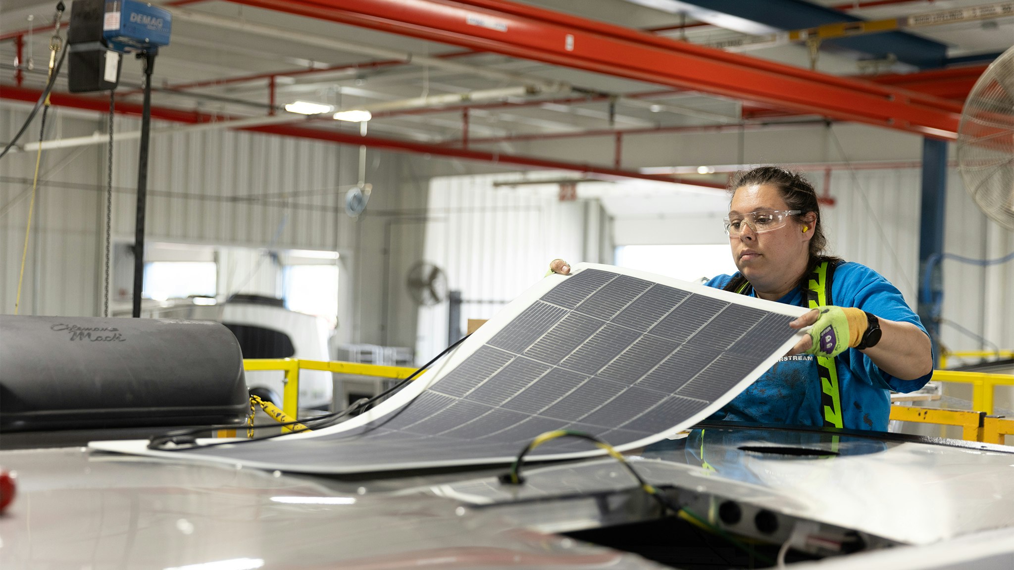 An Airstream employee putting on the solar panels on an Airstream Basecamp travel trailer in Ohio.