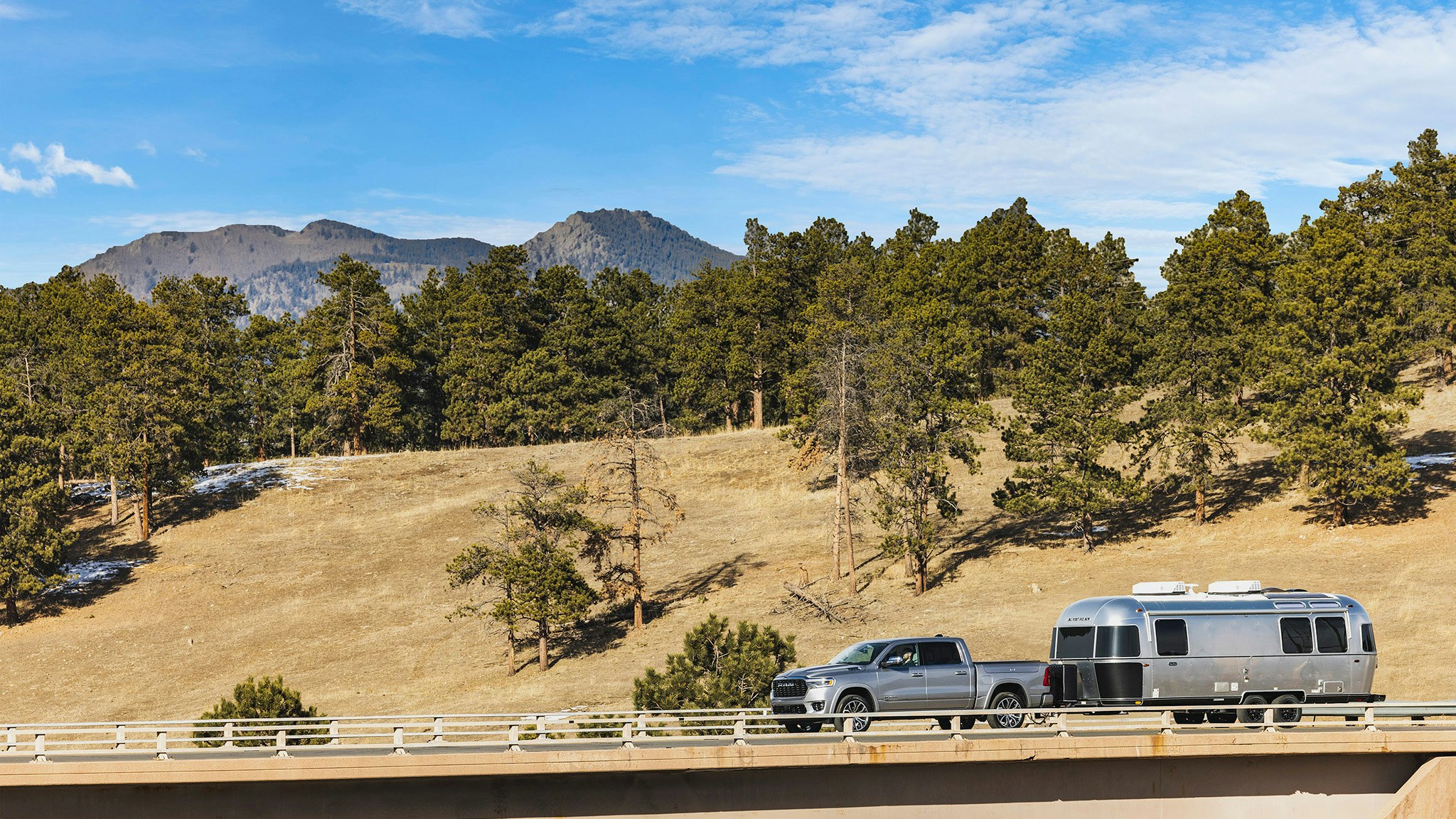 Airstream Midnight Flamingo FC25 Driving on Bridge Hero 16-9